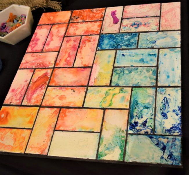 ALCOHOL INK MOSAIC | Ceramic Tiles, Sharpie Marker, Pipettes | Our littlest learners explored color on ceramic tile with resident artist, Krista Story. Students used fine motor skills to use the pipettes to experiment with the resist technique, using a special (and safe!) solution of rubbing alcohol and water that repelled the colors from the ink.