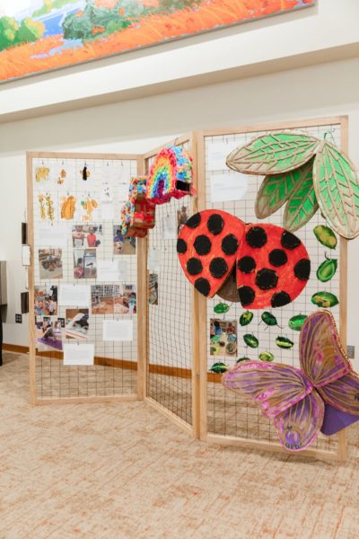 BUG BACKPACKS |  Paint on Cardboard | Wearable bug backpacks were created collaboratively by resident artist, Alex Espy, students, and families. Children wore these on the lawn of the Nelson Atkins Art Museum for their annual picnic, while gaining exposure to the artistic community in Kansas City.