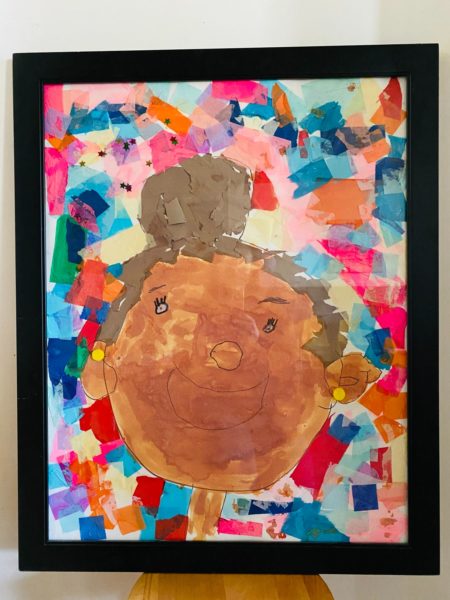 MS. MATRIKA | Oil Pastel, Tissue Paper, Watercolor on Posterboard | Through process-based art practices, children worked together to honor and create this image of one of our teachers, Ms. Matrika.